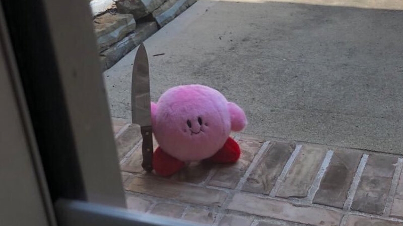 Kirby holding a knife